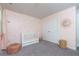 Charming Bedroom with pink walls, plush carpeting, and a white crib at 5620 Berney Cir, Powder Springs, GA 30127