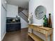 Elegant foyer with console table, dark floors and staircase at 5620 Berney Cir, Powder Springs, GA 30127