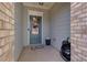 Cozy front porch featuring decorative brick and a blue front door with glass panels at 5620 Berney Cir, Powder Springs, GA 30127