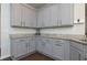 Kitchen featuring gray cabinets, granite countertops and stainless steel hardware at 5620 Berney Cir, Powder Springs, GA 30127