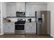 Updated kitchen showcasing stainless steel appliances, gray cabinets, and granite countertops at 5620 Berney Cir, Powder Springs, GA 30127