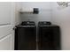 Functional laundry room featuring modern, black, front-load washer and dryer at 5620 Berney Cir, Powder Springs, GA 30127