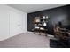 Office space with a black accent wall, a bookshelf, and a rolling chair at 5620 Berney Cir, Powder Springs, GA 30127