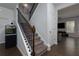Carpeted staircase with dark wood and iron railings leading to upper level at 5620 Berney Cir, Powder Springs, GA 30127