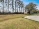 Expansive backyard with mature trees, a storage shed, and a concrete slab, ideal for outdoor activities at 7782 Wethersfield Dr, Jonesboro, GA 30236