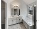 Bathroom featuring double sinks, soaking tub, and natural light at 7782 Wethersfield Dr, Jonesboro, GA 30236