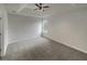 Neutral bedroom design showcasing a decorative tray ceiling, ceiling fan and plush gray carpeting at 7782 Wethersfield Dr, Jonesboro, GA 30236