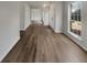Long hallway featuring new flooring and lots of natural light; perfect for showcasing artwork at 7782 Wethersfield Dr, Jonesboro, GA 30236