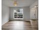 Inviting living room with large window and new flooring; a great space for relaxation and entertaining at 7782 Wethersfield Dr, Jonesboro, GA 30236