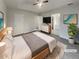 Serene bedroom featuring a tray ceiling, soft lighting, and ensuite access at 7782 Wethersfield Dr, Jonesboro, GA 30236