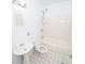 Clean bathroom featuring tiled floors, a pedestal sink, and a combined tub and shower at 1191 Beechview Se Dr, Atlanta, GA 30316