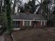 Quaint red brick home with a screened-in porch, nestled among mature trees in a quiet neighborhood setting at 1191 Beechview Se Dr, Atlanta, GA 30316