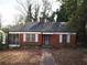 Charming red brick home featuring a classic design with a small chimney and a lovely screened-in front porch at 1191 Beechview Se Dr, Atlanta, GA 30316