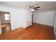 Sunlit living room boasts beautiful hardwood floors, a ceiling fan, and a charming decorative fireplace at 1191 Beechview Se Dr, Atlanta, GA 30316