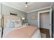 Cozy bedroom featuring soft blue walls, a neutral headboard, and hardwood floors at 301 10Th Ne St # 15, Atlanta, GA 30309