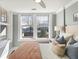 Bright bedroom featuring neutral colors, a ceiling fan, and large windows at 301 10Th Ne St # 15, Atlanta, GA 30309