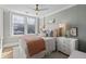 Bright bedroom featuring neutral colors, a ceiling fan, and large windows at 301 10Th Ne St # 15, Atlanta, GA 30309