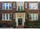 Beautiful brick apartment building with a charming entrance, landscaping, and string lights at 301 10Th Ne St # 15, Atlanta, GA 30309