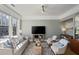Bright living room with a comfortable sofa, stylish furniture, a television and expansive windows at 301 10Th Ne St # 15, Atlanta, GA 30309