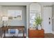 Home office nook with a vintage desk, gold mirror, and serene artwork with a bright light fixture at 301 10Th Ne St # 15, Atlanta, GA 30309