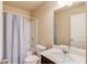 Bathroom with tiled shower, toilet, white marble sink, and mirrored cabinet at 4288 Buford Valley Way, Buford, GA 30518