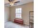 Cozy bedroom featuring a ceiling fan, window, and rustic storage trunk at 4288 Buford Valley Way, Buford, GA 30518