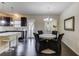 Open-concept dining area features modern chandelier, dark wood floors, and connects to the kitchen at 4288 Buford Valley Way, Buford, GA 30518