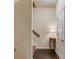 Neutral hallway featuring dark laminate flooring, a charming accent table and a staircase leading to the upper level at 4288 Buford Valley Way, Buford, GA 30518