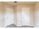 Hallway with two white doors and modern gray flooring at 4288 Buford Valley Way, Buford, GA 30518
