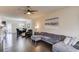 Open-concept living room flows into the dining area, featuring hardwood floors, a gray sectional, and natural light at 4288 Buford Valley Way, Buford, GA 30518