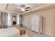 Spacious main bedroom features a ceiling fan, wood look floors, and an armoire at 4288 Buford Valley Way, Buford, GA 30518