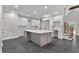 Spacious kitchen with a large island, white cabinets, and tiled floors at 1066 Fairway Valley Dr, Woodstock, GA 30189