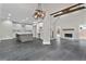 Open-concept living space with modern kitchen, fireplace, and striking black-tiled flooring at 1066 Fairway Valley Dr, Woodstock, GA 30189