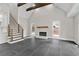 Bright living space featuring fireplace, wood beams, and staircase with iron railing at 1066 Fairway Valley Dr, Woodstock, GA 30189