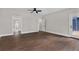 Main bedroom featuring hardwood floors, ceiling fan, and an ensuite bathroom at 1066 Fairway Valley Dr, Woodstock, GA 30189