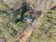 Aerial view of a home nestled in a dense forest, revealing its roof layout and surrounding greenery at 1405 Roper Rd, Canton, GA 30115