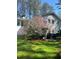 Exterior of home with blooming azalea adding color, shade, and privacy to the property at 1405 Roper Rd, Canton, GA 30115