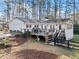 Backyard featuring a spacious wooden deck, perfect for outdoor dining and entertaining at 1405 Roper Rd, Canton, GA 30115