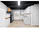 Basement with white cabinetry, full-sized appliances, and modern flooring. An ideal kitchenette for guests at 1405 Roper Rd, Canton, GA 30115