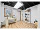 Finished basement with a desk, laminate flooring, and a bright window at 1405 Roper Rd, Canton, GA 30115
