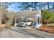 Beautiful carport with luxury SUV, a flagpole, and well-manicured landscaping enhance the exterior at 1405 Roper Rd, Canton, GA 30115