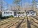 Inviting single-story home with a white exterior, dark shutters, and a well-manicured lawn at 1405 Roper Rd, Canton, GA 30115