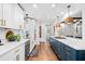 Open kitchen with white cabinets, an island with gas range, and stainless steel appliances at 1405 Roper Rd, Canton, GA 30115