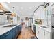 Modern kitchen featuring white cabinets, stainless steel appliances, and a center island at 1405 Roper Rd, Canton, GA 30115