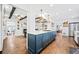 Bright, open kitchen with a central island, hardwood floors, and modern appliances at 1405 Roper Rd, Canton, GA 30115