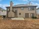 View of the two-story home's backyard with a patio and a privacy fence at 2708 Stockbridge Way, Dacula, GA 30019