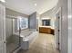 Bright bathroom featuring a soaking tub, a separate shower, and a large vanity with double sinks at 2708 Stockbridge Way, Dacula, GA 30019
