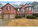 Charming two-story brick home with a well-manicured front yard and a two-car garage at 2708 Stockbridge Way, Dacula, GA 30019