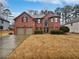 Charming two-story brick home with a well-manicured front yard and a two-car garage at 2708 Stockbridge Way, Dacula, GA 30019