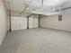 The large garage with an epoxy floor and overhead storage racks is ready for your vehicles at 2708 Stockbridge Way, Dacula, GA 30019